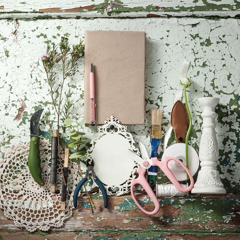 A pen on top of a book with DIY items below