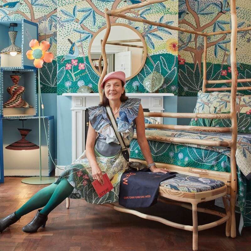 A woman sitting on a bedside bench