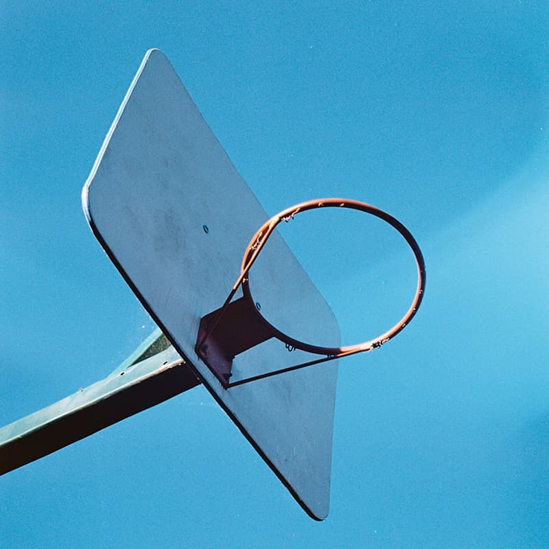 A basketball hoop with blue sky as background