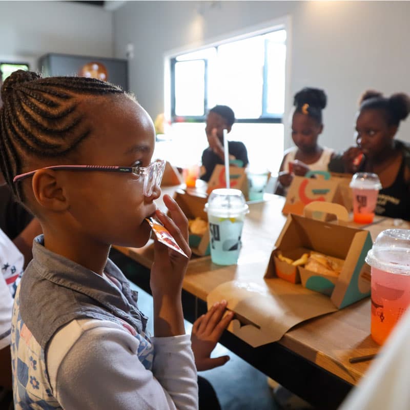 A kid eating Nando's