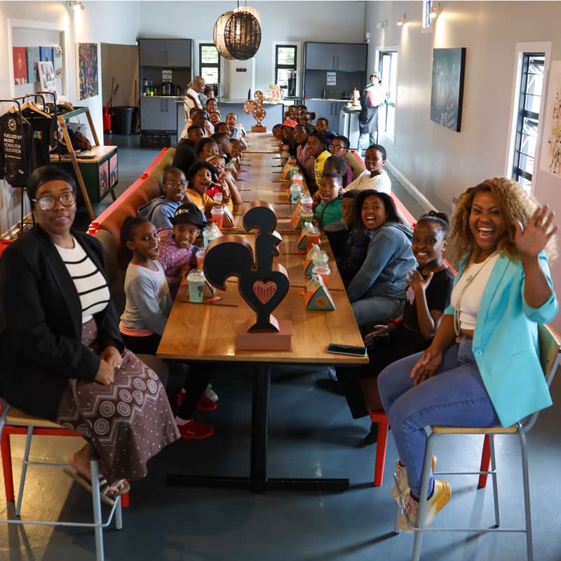 kids and adults sitting at a table
