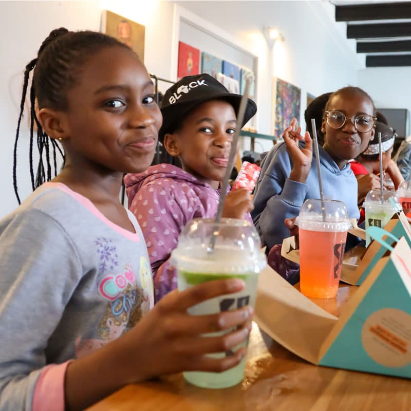 Kids smiling drinking a soda