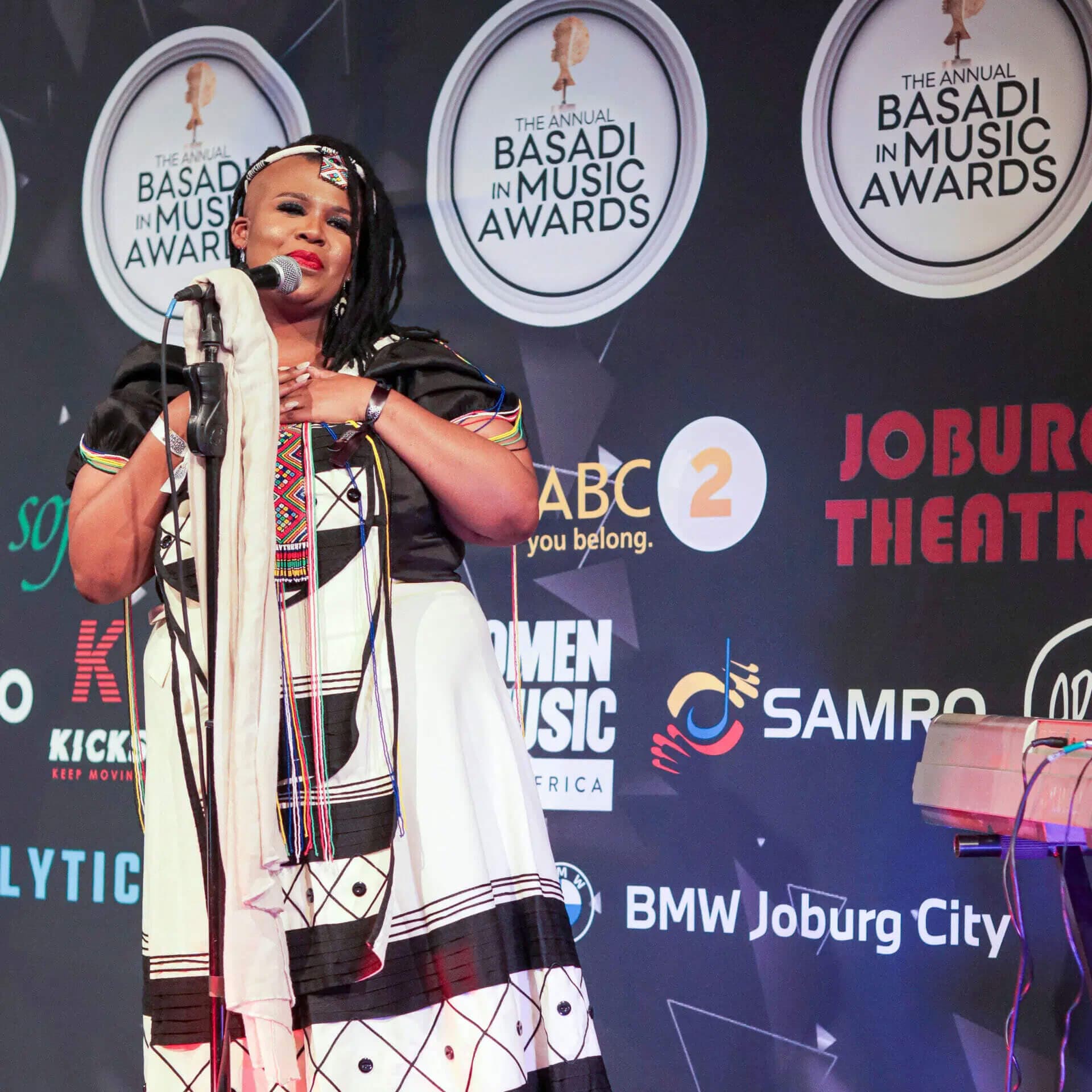 Noluthando Ngema speaking into a mic